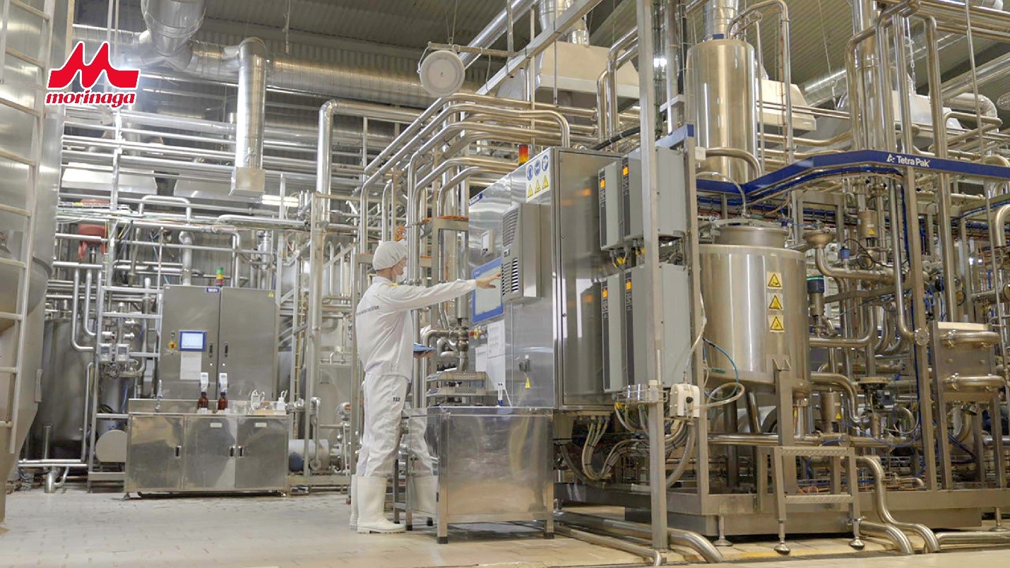 A person in a white coverall working in a factoryAI-generated content may be incorrect.